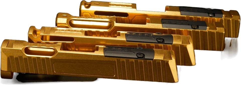Four gold custom pistol slides