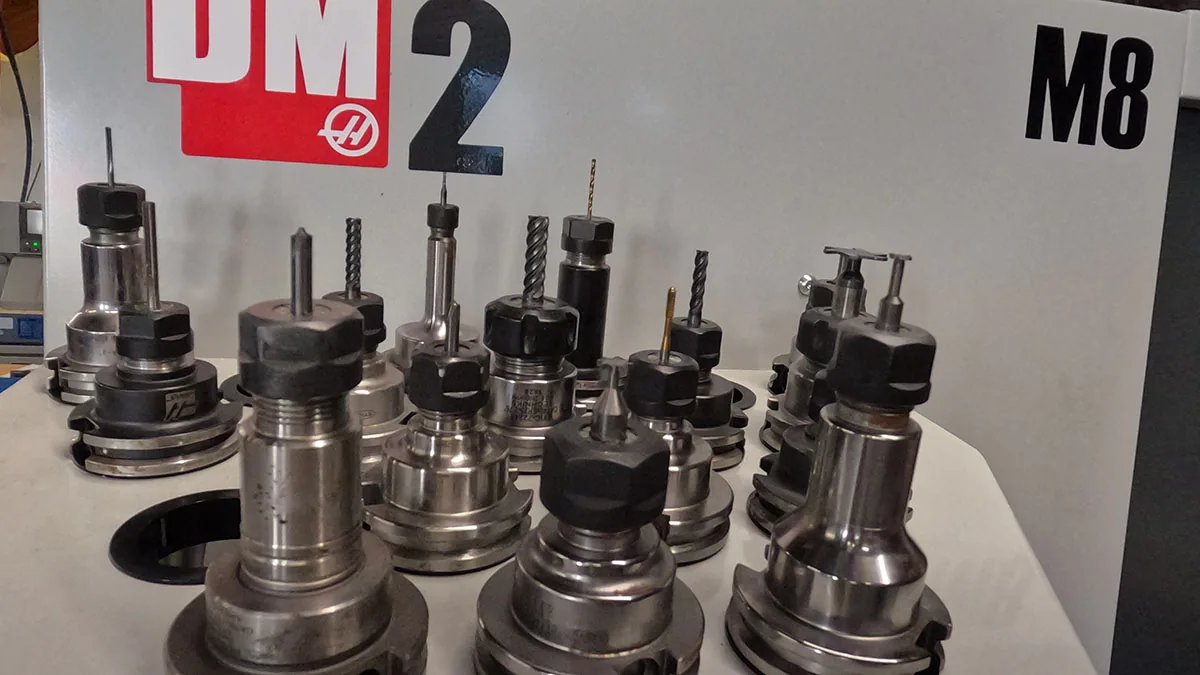 CNC tool holders lined up in front of a DM2 machining center in the NDZ shop