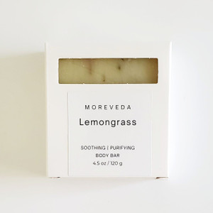 Handmade lemongrass soap bar packaged inside a white box with a window for viewing. Handmade lemongrass soap bar packaged inside a white box with a window for viewing.