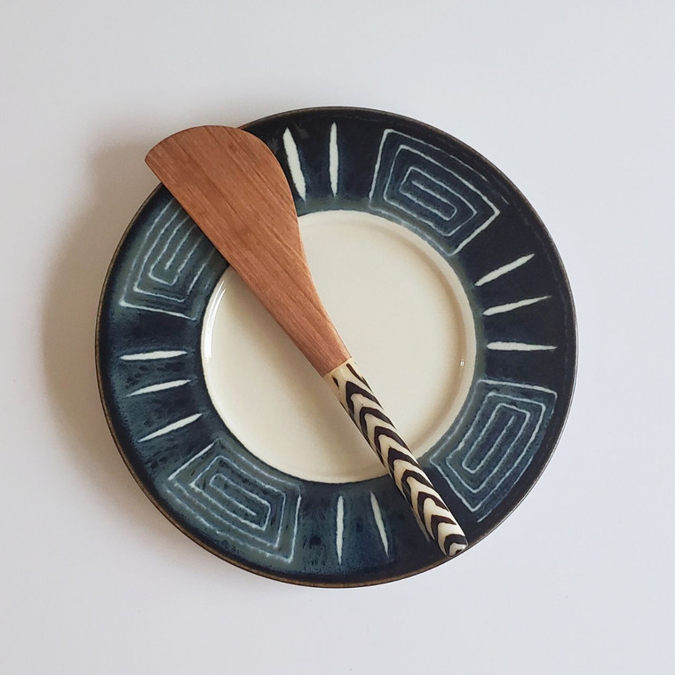 olive wood butter knife on plate