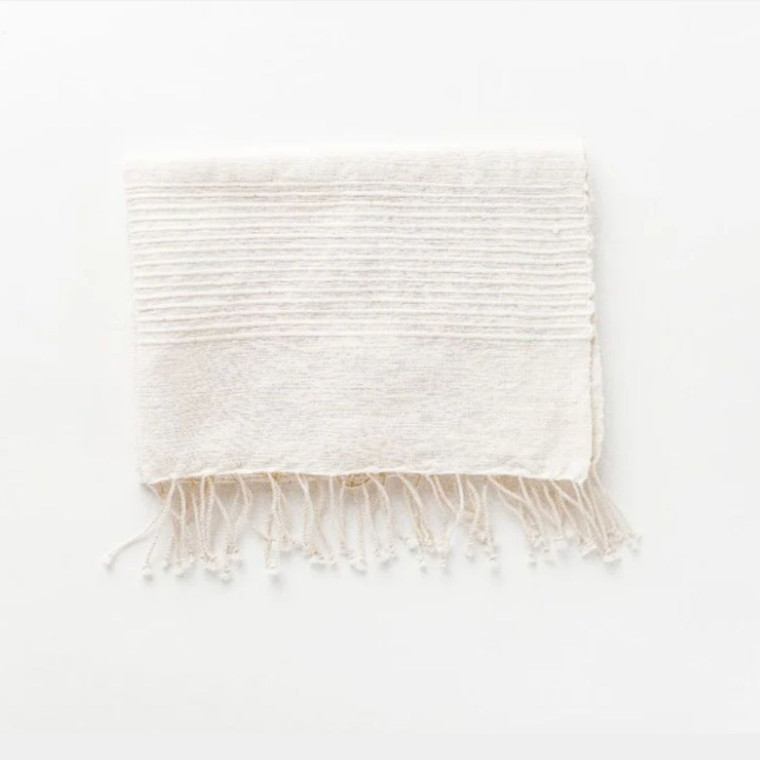 Handwoven cotton hand towel with tassels. Adds a touch of bohemian charm to your bathroom while providing a soft and absorbent way to dry your hands.
