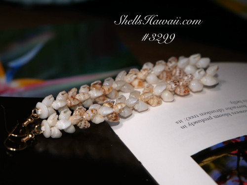 Pikake-style Niʻihau shell earrings handcrafted with 3.5 strands of white and golden Momi shells, arranged to resemble the delicate shape of Pikake flowers. Finished with 14K gold-filled findings, these earrings reflect the grace and tradition of Hawaiian jewelry.