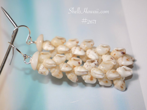 Close up of Pikake style Niʻihau shell earrings using off white Momi shells with brown spotted details and soft pearl like shine