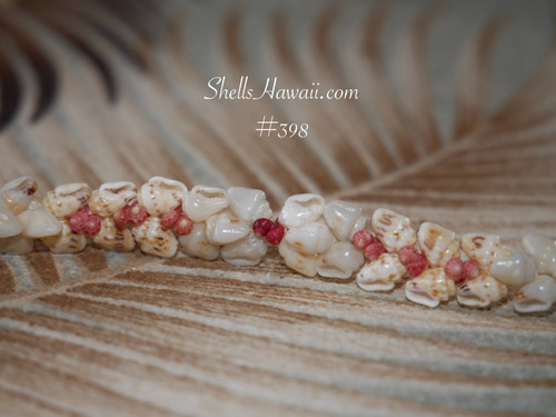Close detail of kahelelani shell bracelet showing pink flower tones and speckled momi shells in kipona design, authentic Niihau shell jewelry