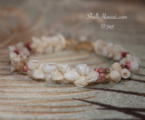 7.5" Niʻihau shell bracelet kipona style with momi shells and kahelelani shells in red burgundy, green, and pink flower accents full view #395