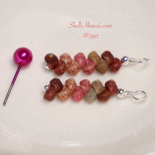 This photo shows the tiny Kahelelani shells before assembly, highlighting the natural mix of burgundy, pink, brown, and gray tones. The close-up view shows the shell shape, texture, and careful matching used to create these Hawaiian shell earrings.