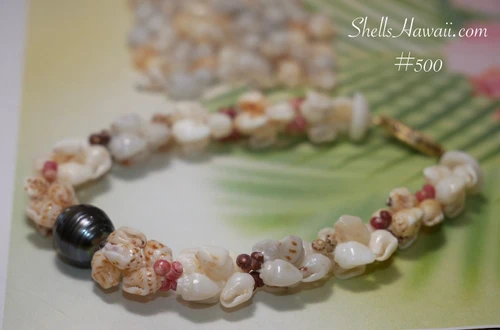 nibl_500
Hawaiian shell bracelet featuring Momi and Kahelelani shells in Kipona style with 10.23mm dark peacock Tahitian pearl centerpiece, handmade Hawaiian shell jewelry gift