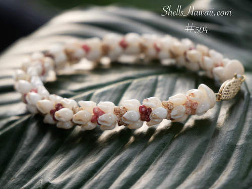 Authentic Hawaiian shell bracelet shown in close up side way view featuring double-double Pikake tied shellwork with creamy Momi shells and colorful Kahelelani accents. Genuine Niʻihau shell jewelry bracelet inspired by traditional Hawaiian shell artistry.