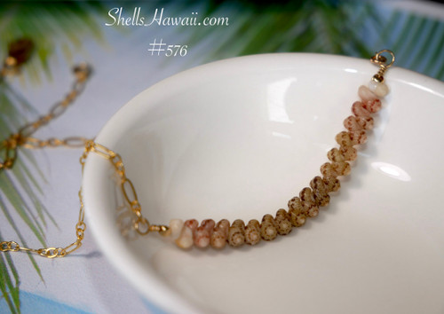 Angled close up of genuine Kahelelani shell necklace featuring soft ombre green Niihau shells with floating minimalist Hawaiian jewelry design on a fancy Italian 14k gold filled chain.