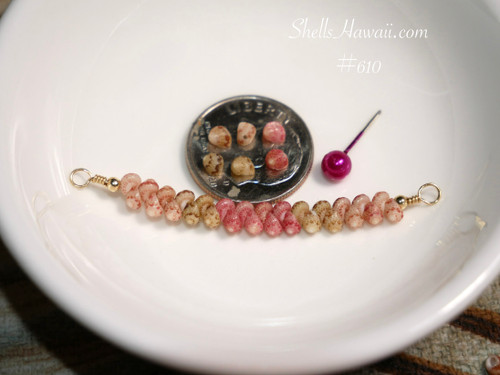 Dainty ocean-inspired Kahelelani shell necklace from Niʻihau shown beside a coin for size reference featuring Keʻokeʻo, green, and pink flower shell colors in an elegant floating design.