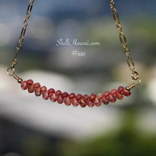 pd_616
Burgundy Kahelelani shell minimalist necklace displayed hanging naturally to showcase the softly curved floating design, handcrafted shell arrangement, and rich natural burgundy color variations of genuine Kauaʻi Kahelelani shells along the gold filled chain.