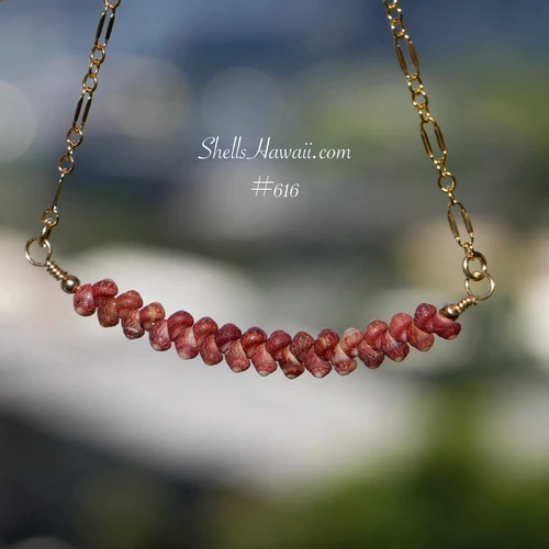 pd_616
Burgundy Kahelelani shell minimalist necklace displayed hanging naturally to showcase the softly curved floating design, handcrafted shell arrangement, and rich natural burgundy color variations of genuine Kauaʻi Kahelelani shells along the gold filled chain.