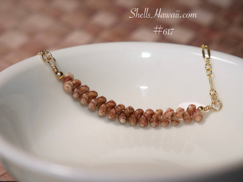 pd_617
Close-up overall view of the floating shell pendant resting inside a white ceramic bowl highlighting the smooth ombré transition of soft blush, creamy neutral, and chocolate brown Kahelelani shells from Kauaʻi.