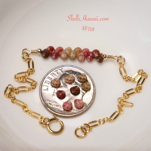 bl_701
Authentic Niʻihau shell bracelet displayed beside a dime on a white dish showing the tiny scale and natural beauty of genuine Kahelelani shells in black, brown, red burgundy, pink flower, keʻokeʻo, and green tones accented with 14k gold filled chain. Delicate minimalist Hawaiian shell jewelry handcrafted in Hawaii.