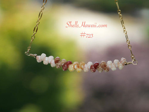 Authentic Niʻihau shell necklace handcrafted with rare size 15 Kahelelani shells in off white keʻokeʻo, ice-cream kamoa, green, yellow kamoa, and deep red burgundy tones arranged in a floating minimalist design on delicate 14k gold filled chain.