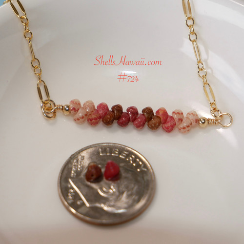 Close-up of handcrafted Hawaiian shell necklace featuring genuine size 11 Kahelelani shells from Niʻihau in ombre shades of off white, pink flower, brown, and rich burgundy displayed beside a dime for size comparison.