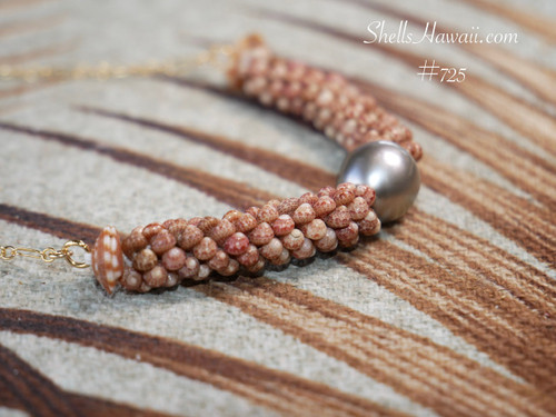 Detailed side view of triple strand poepoe Kahelelani shell necklace showing intricate handcrafted shell arrangement and silver tone Tahitian pearl centerpiece with 14k gold filled chain.