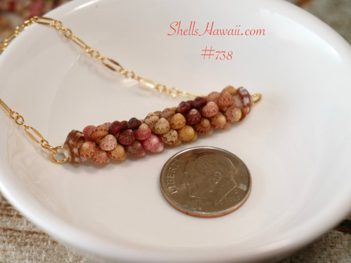 Authentic Hawaiian shell pendant necklace handcrafted with genuine Kauaʻi Kahelelani shells in a two-strand Poepoe design, displayed beside a U.S. dime to show the 1 1/4-inch shell pendant size.