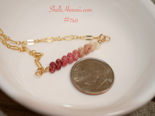 Authentic Kahelelani shell bar necklace handcrafted with genuine size 11 shells from Niʻihau, displayed beside a U.S. dime to show the 1-inch ombre floating shell section.