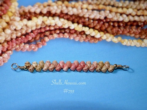pd_755
Close-up of genuine Niʻihau Kahelelani shells in light green, Keʻokeʻo white and soft pink arranged in a Hawaiian minimalist bar necklace design.