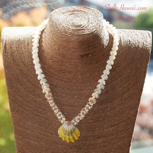 ninl_2029
Niʻihau shell necklace #2029 displayed on necklace stand, Kipona style Momi and Kahelelani lei with Oʻahu Sunrise shell pendant