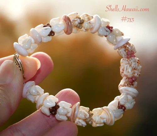 nibl_713
Close-up of handmade Niʻihau Kipona style shell bracelet featuring white and light blue Momi, brown spotted Momi, colorful Kahelelani and Hawaiian Puka shells.