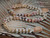 Full overview of Niʻihau shell lei showing a beautiful combination of Momi and Kahelelani shells in white, black-spotted, yellow, rare blue, green, pink, red burgundy, brown, black, and natural Keʻokeʻo tones, finished with brown granulated cowrie shell clasp. 21 inch Kipona style lei, handcrafted Hawaiian shell jewelry, one of a kind statement piece priced at $2550 ニイハウシェル ネックレス