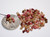 Mixed-color size 11 Kahelelani shells from Niʻihau shown beside a coin and pink head pin for size comparison. These small Hawaiian shells are commonly used for Heliconia, Poepoe, Kipona, earrings, bracelets, and delicate shell jewelry making.