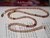 Handmade Hawaiian lei combining tradition, history, and radiant natural shell beauty; ideal for collectors, ceremonial wear, or anyone wishing for dignity and color.