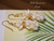 Authentic Niʻihau shells (モミシェル & カヘレラニ シェル), blending creamy white Keʻokeʻo Momi with golden yellow Lenalena Kahelelani in a playful Pineapple design. Photos show true colors.