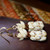 Close-up of Pineapple motif showing layered off-white and black shells; shells strung in four strands, jump ring to hook length 1⅛″, 14K gold-filled findings.