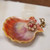 Unique Hawaiian sunrise shell pendant featuring golden yellow, olive green, and pink tones with Niʻihau Kahelelani shells