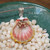 Golden yellow and pink Hawaiian sunrise shell pendant with authentic Niʻihau shells and Kahelelani flower accent