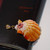 Niʻihau shell jewelry pendant with authentic Kahelelani shells and rare orange and pink sunrise shell
