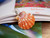 Orange and white Hawaiian sunrise shell pendant with authentic Niʻihau shells and Kahelelani flower accent
