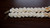 Option 3 (focus: Necklace):
Handcrafted shell necklace—21″ Crown Flower lei made with blue ʻUliʻuli, yellow Lenalena, and white Keʻokeʻo Momi shells from Ni‘ihau