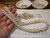 21 ¼" authentic Niʻihau shell lei handcrafted in Pikake style featuring rare Momi ʻŪliʻuli ʻĀhiehie (light blue) and Momi Lenalena (golden yellow). Finished with 14k gold-filled clasp.