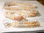 Elegant Hawaiian jewelry (ニイハウシェルジュエリー) — a 40" Single Pikake style Niʻihau Momi lei with 3" earrings. Crafted with Keʻokeʻo white, Lenalena yellow, ʻŪliʻuli ʻĀhiehie blue, and caramel shells.