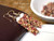 Fun color Kahelelani shell earrings from Kauaʻi handcrafted in a 4-strand Poepoe tied style with pink, tan, orange, and burgundy shells.