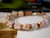 Luxury Hawaiian bracelet—7¾″ shell bracelet blending white Momi with green, pink, and burgundy Kahelelani shells in Crown Flower and Poepoe style