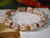 7¾" Niʻihau shell bracelet in blended Momi Crown Flower and Kahelelani Poepoe tied style, showcasing ʻUliʻuli, Lenalena, ʻŌmaʻomaʻo, ʻAkala Pua, and ʻUlaʻula hues