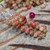 close up Niihau shell earrings Kahelelani shells green pink flower burgundy keokeo detailed minimalist Hawaiian jewelry