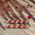 Close-up of dainty minimalist earrings featuring light brown and burgundy Kahelelani shells from Kauaʻi, carefully wire wrapped with a head pin to show size comparison, a soft and delicate Hawaiian shell jewelry piece perfect as a gift for her