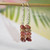 nier_3163
Kahelelani shell earrings hanging on hook showing beautiful pink, green, burgundy, and brown Kahelelani shells used to create this design, Hawaiian shell earrings under $100