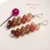 Kahelelani shell earrings laid flat showing burgundy, chocolate brown, green, pink and off white shells in soft drop design, tiny Hawaiian shell jewelry from Kauai, lightweight everyday ocean inspired earrings gift for her
