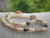 Niihau shell lei with off white Momi shells, brown, pink and red Kahelelani shells, light brown cowrie shell clasp and Tahitian pearl accents, unique modern Hawaiian shell necklace gift under $1500