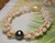 Close up Niihau Momi shell bracelet showing ombre yellow and off white shells with Pikake tying technique detail, baroque peacock Tahitian pearl and 14k gold filled safety clasp, handcrafted jewelry featuring tiny natural shells from Niihau Hawaii, perfect island style gift