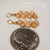 Tiny yellow Kamoa shell earrings from Niihau shown next to a dime for size comparison, featuring size 14 shells in a 3/4 inch drop design, priced at $75.