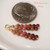 Dainty mini Hawaiian shell drop earrings with Kahelelani shells in burgundy, pink and natural ombre colors, lightweight 3/4" style finished with 14k gold filled hooks, Hawaiian shell jewelry gift for her under $100