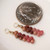 Close-up of mini Kahelelani shells in ombre pink, burgundy, and natural brown tones from Kauai next to a coin for size comparison, Hawaiian shell earrings gift for her under $100